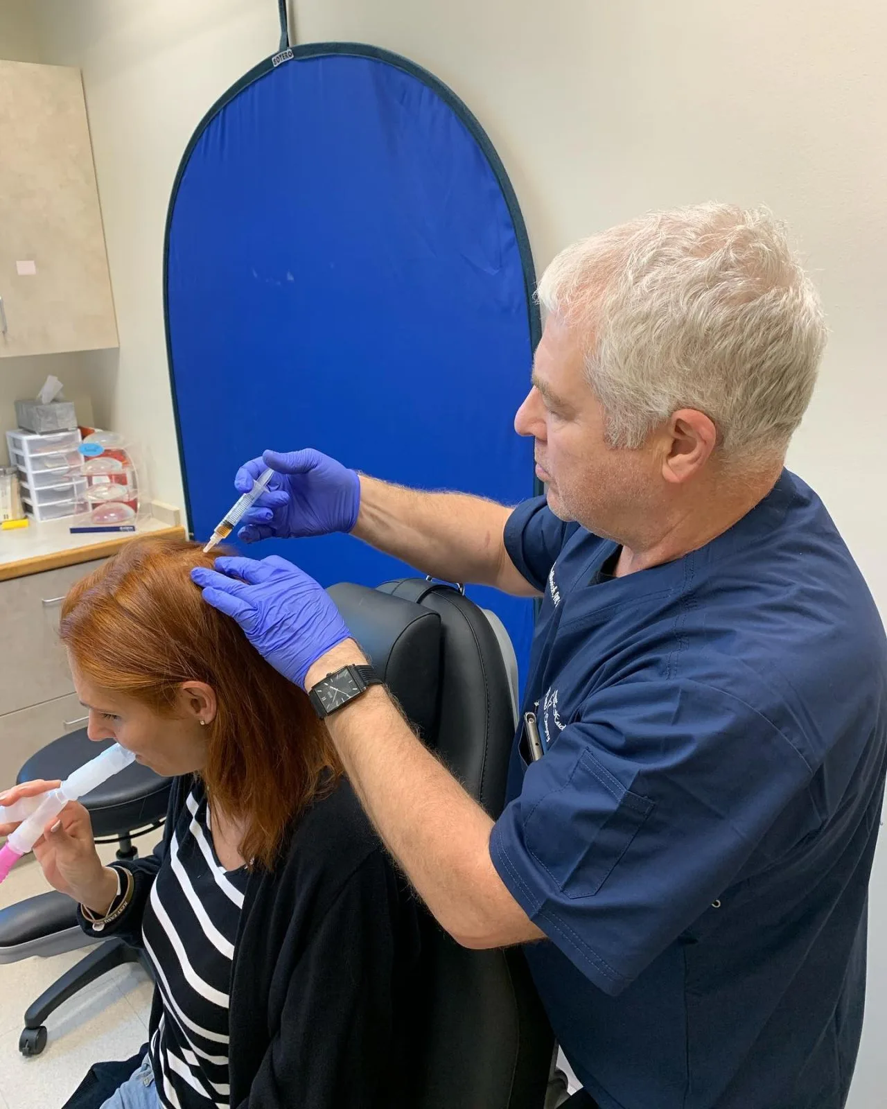Dr. Boris Mordkovich administering PRP injections to a patient's scalp in the Englewood Cliffs clinic